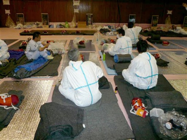 In this April 16, 2011 photo released Wednesday, April 20, 2011 by Ehime University Medical Department Prof. Takeshi Tanigawa via Kyodo News, workers, mostly employees of Tokyo Electric Power Co., engaged in operations at the tsunami-damaged Fukushima Dai-ichi Nuclear Power Plant, take rest inside a gymnasium that serves as their temporary dormitory at Fukushima Dai-ni Nuclear Power Plant in Naraha, 14 kilometers (9 miles) south of the former plant in Fukushima Prefecture, Japan. Workers battling the crisis at the Japan's stricken nuclear plant suffer from insomnia, show signs of dehydration and high blood pressure and are at risk of developing depression or heart trouble, Tanigawa who met with them said Wednesday, April 20, 2011. (AP Photo/Ehime University Medical Department Prof. Takeshi Tanigawa via Kyodo News) JAPAN OUT, MANDATORY CREDIT, NO LICENSING IN CHINA, HONG KONG, JAPAN, SOUTH KOREA AND FRANCE, EDITORIAL USE ONLY, BEST QUALITY